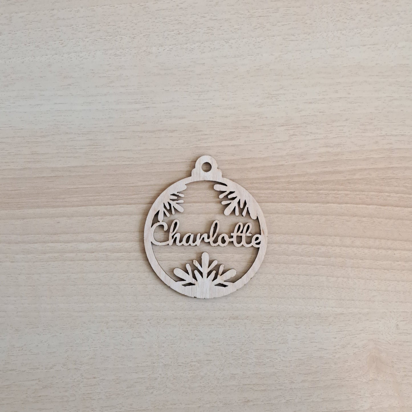 laser cut ornament with three snowflakes and name Charlotte cut